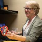 Lisa Oakes smiling while testing a subject